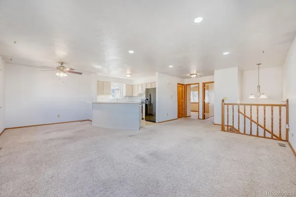 a view of an empty room with a kitchen