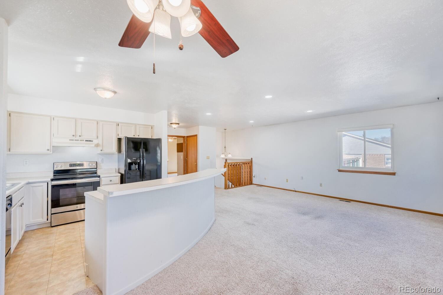 430 Elizabeth Street Fort Lupton, CO 80621 - Photo 17 of 30 a large kitchen with cabinets and stainless steel appliances