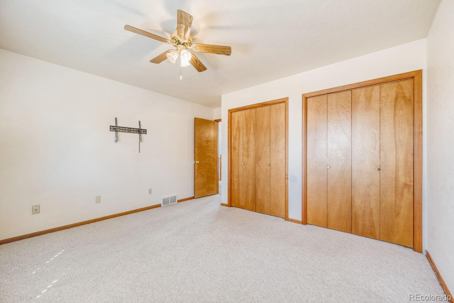 430 Elizabeth Street Fort Lupton, CO 80621 - Photo 19 of 30 an empty room with closet and windows