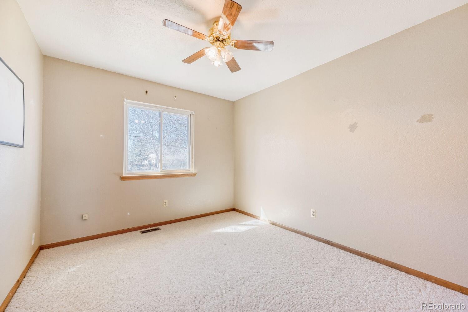 430 Elizabeth Street Fort Lupton, CO 80621 - Photo 20 of 30 an empty room with a window and a fan