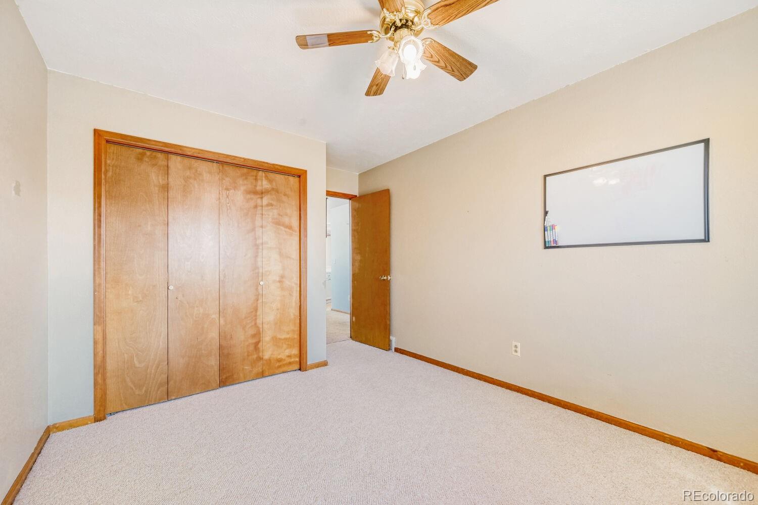 430 Elizabeth Street Fort Lupton, CO 80621 - Photo 21 of 30 a view of a room with a ceiling fan and a window