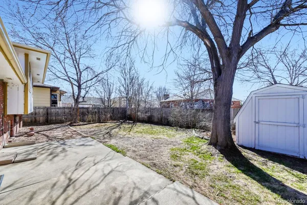 a pathway of a house with backyard and trees