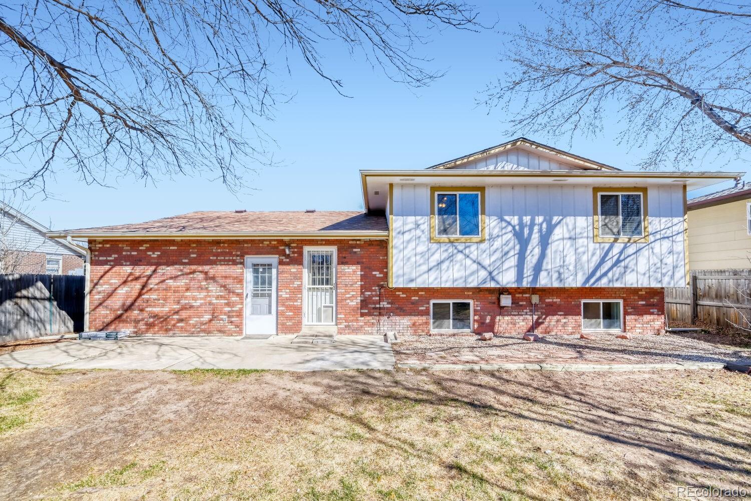 430 Elizabeth Street Fort Lupton, CO 80621 - Photo 25 of 30 a front view of a house with large trees