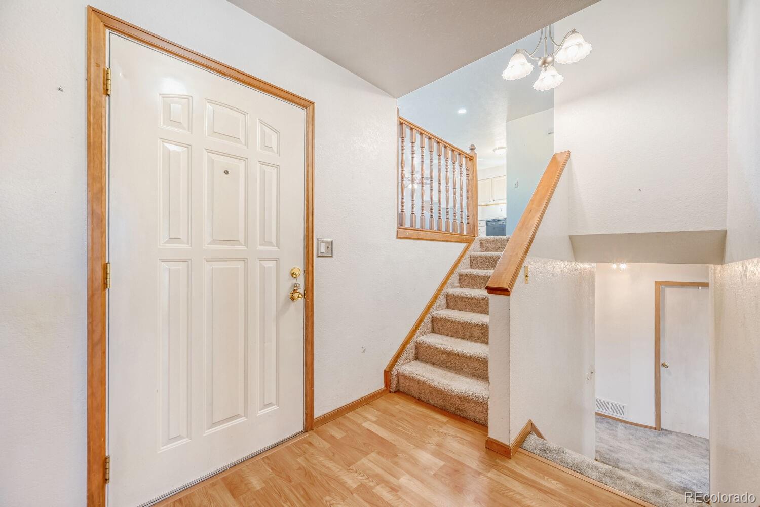 430 Elizabeth Street Fort Lupton, CO 80621 - Photo 4 of 30 a view of entryway with wooden floor and stairs
