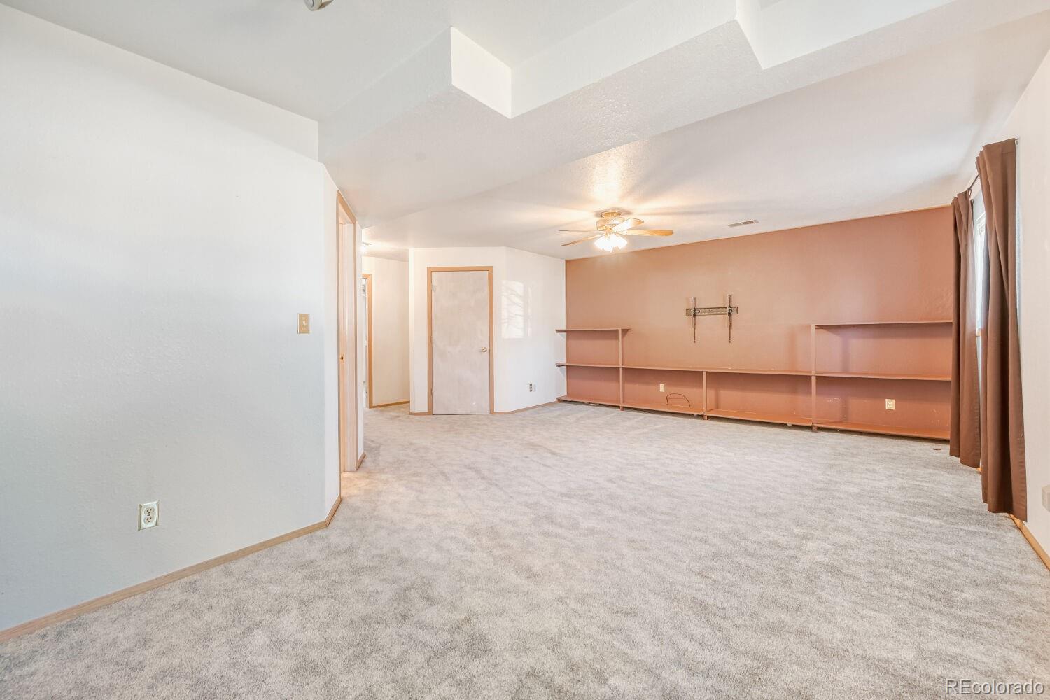 430 Elizabeth Street Fort Lupton, CO 80621 - Photo 9 of 30 an empty room with cabinet and mirrors