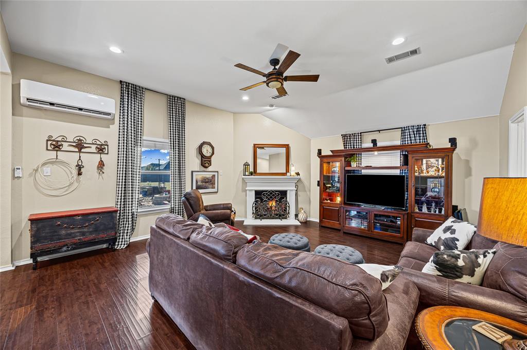 112 Springfield Lane Red Oak, TX 75165 - Photo 13 of 40 a living room with furniture a flat screen tv and a fireplace