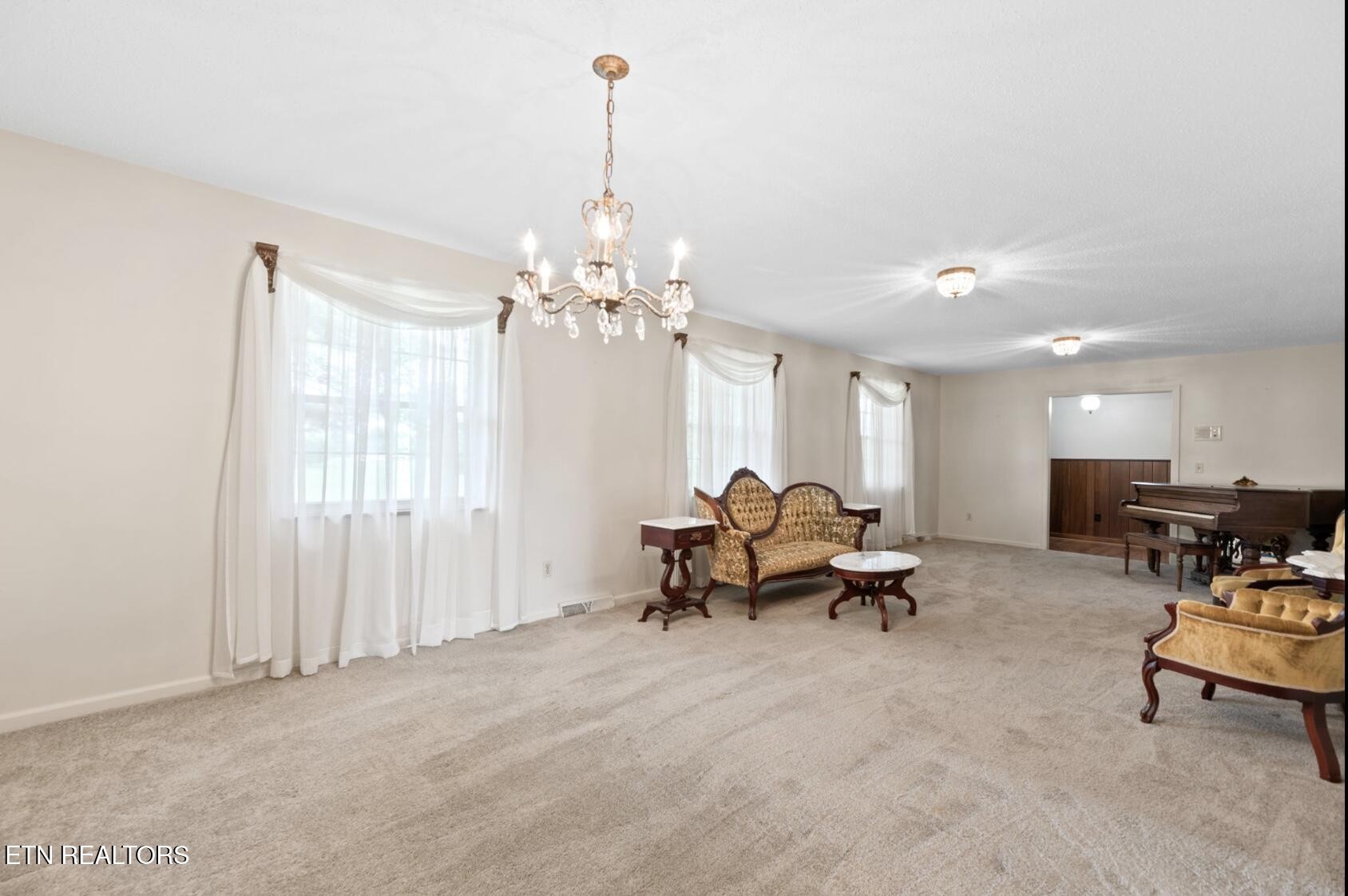 571 Calhoun Drive Greenback, TN 37742 - Photo 16 of 44 a living room with furniture and a chandelier