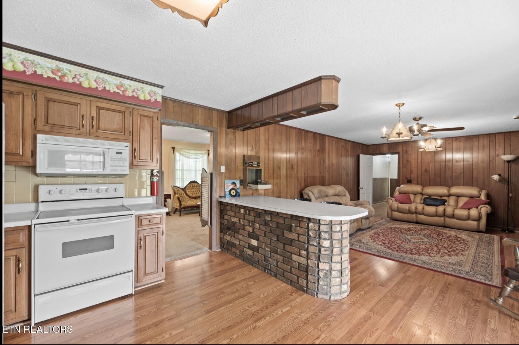 571 Calhoun Drive Greenback, TN 37742 - Photo 19 of 44 a open kitchen with stainless steel appliances granite countertop a stove and a wooden floors