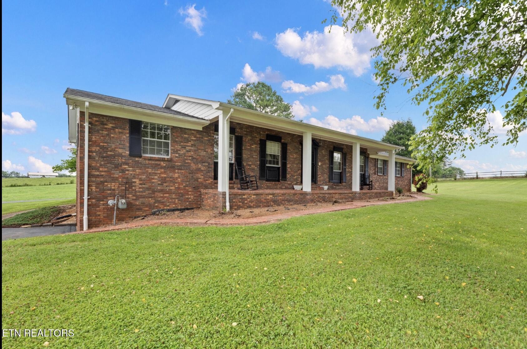 571 Calhoun Drive Greenback, TN 37742 - Photo 3 of 44 a view of a house with a yard and a large tree