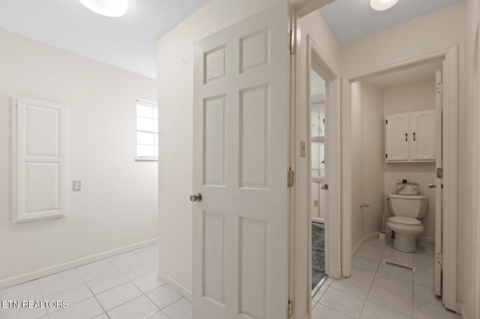 571 Calhoun Drive Greenback, TN 37742 - Photo 37 of 44 a bathroom with a granite countertop toilet a sink and a mirror