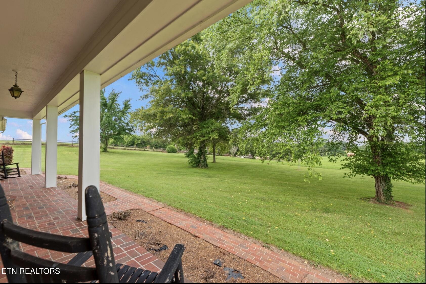 571 Calhoun Drive Greenback, TN 37742 - Photo 6 of 44 a view of a patio with table and chairs potted plants and large tree