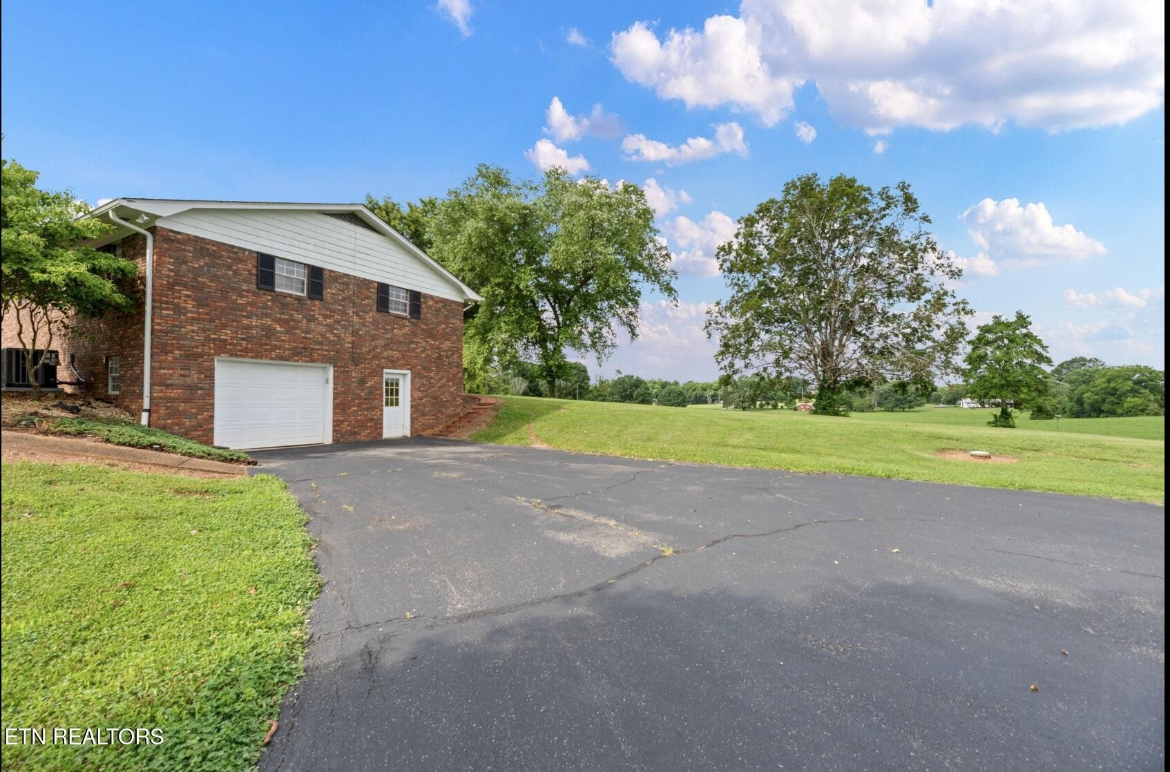 571 Calhoun Drive Greenback, TN 37742 - Photo 7 of 44 a view of a house with a yard and garage