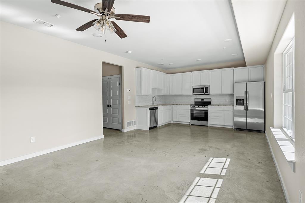 2290 West Tarleton Street, Unit 105 Stephenville, TX 76401 - Photo 2 of 15 a view of a kitchen with refrigerator and a ceiling fan