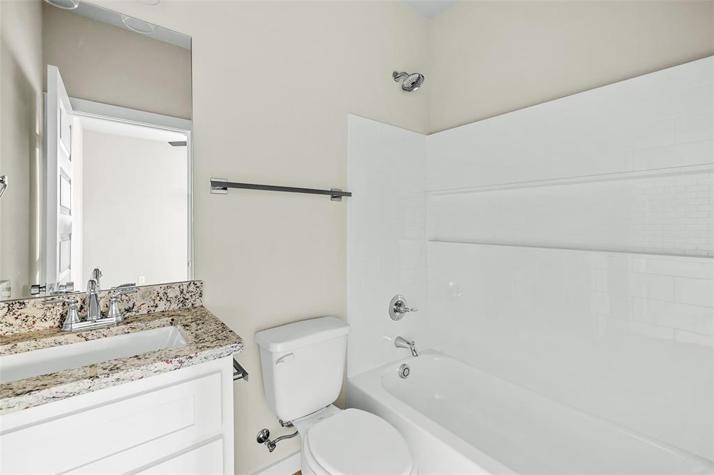 2290 West Tarleton Street, Unit 105 Stephenville, TX 76401 - Photo 10 of 15 a bathroom with a granite countertop sink toilet and shower