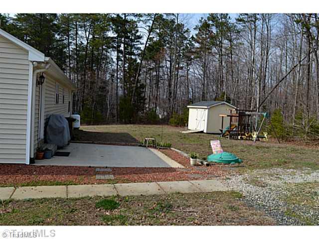 4580 Scythe Road Julian, NC 27283 - Photo 3 of 13 Landscaping. Back yard, patio and storage building