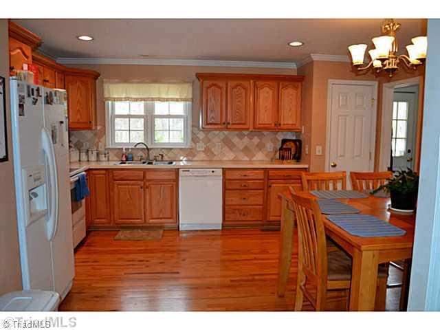 4580 Scythe Road Julian, NC 27283 - Photo 7 of 13 Kitchen. Kitchen has hardwood floors and its an eat in kitchen
