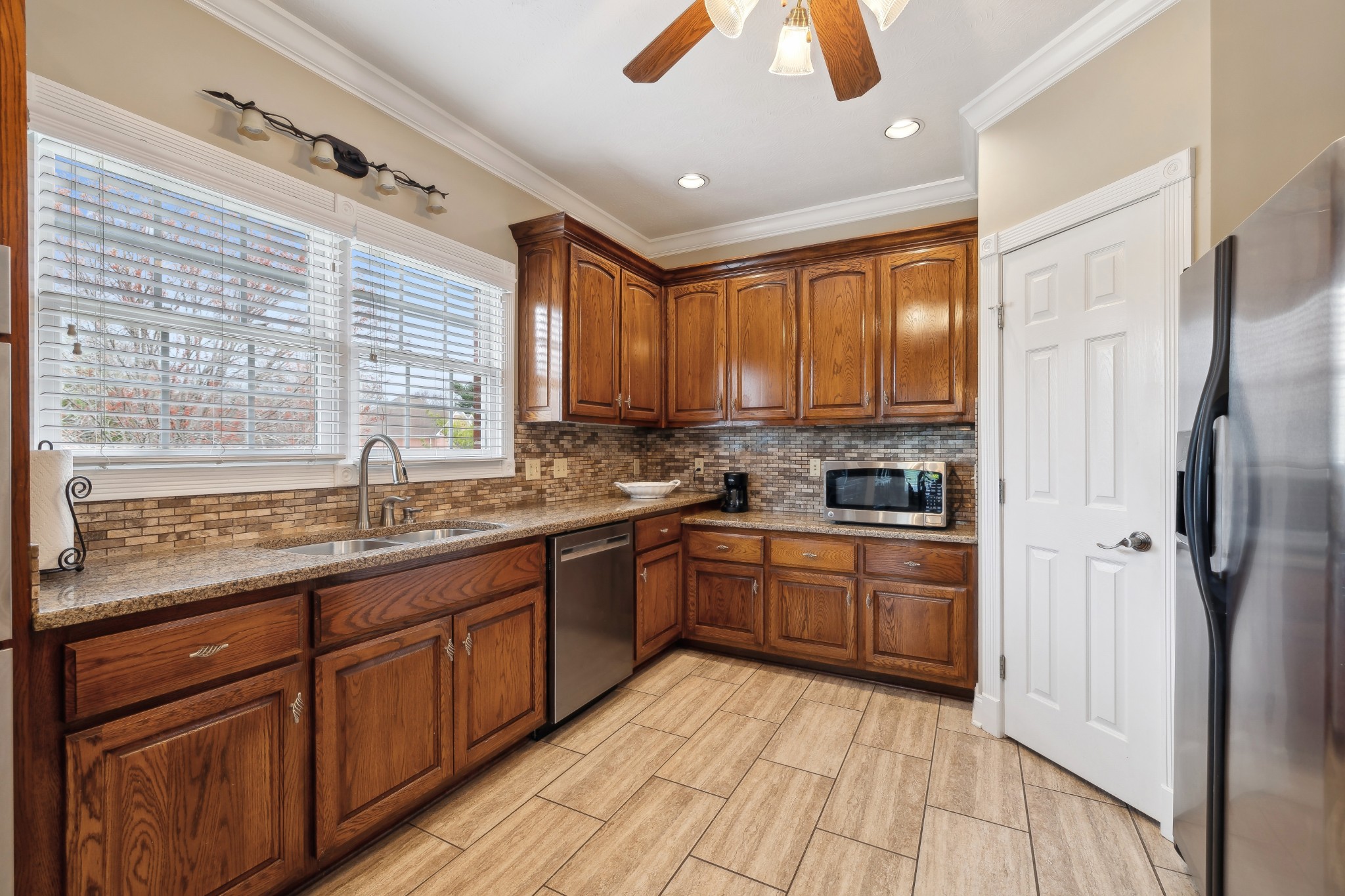 2108 Rodman Boulevard Gallatin, TN 37066 - Photo 17 of 45 a kitchen with stainless steel appliances granite countertop wooden cabinets a refrigerator and a sink
