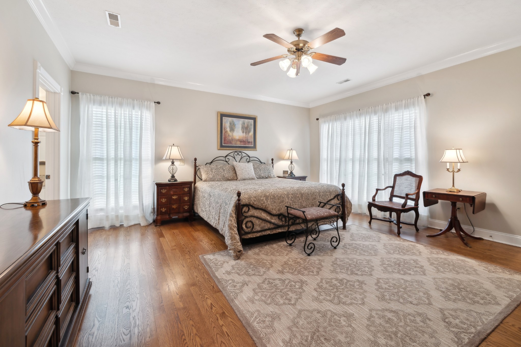 2108 Rodman Boulevard Gallatin, TN 37066 - Photo 20 of 45 a spacious bedroom with a bed a chandelier and window