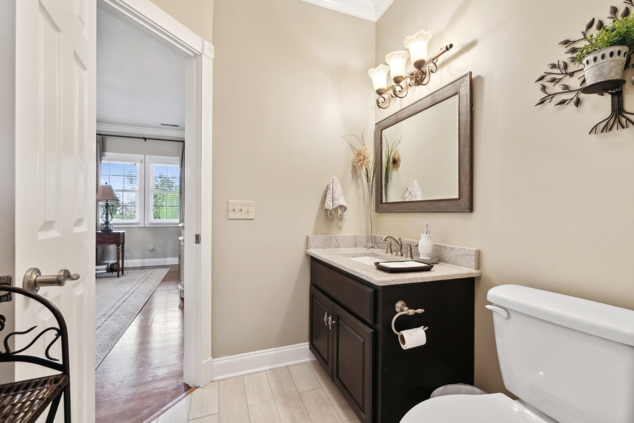 2108 Rodman Boulevard Gallatin, TN 37066 - Photo 29 of 45 a bathroom with a toilet a sink a mirror a vanity and shower