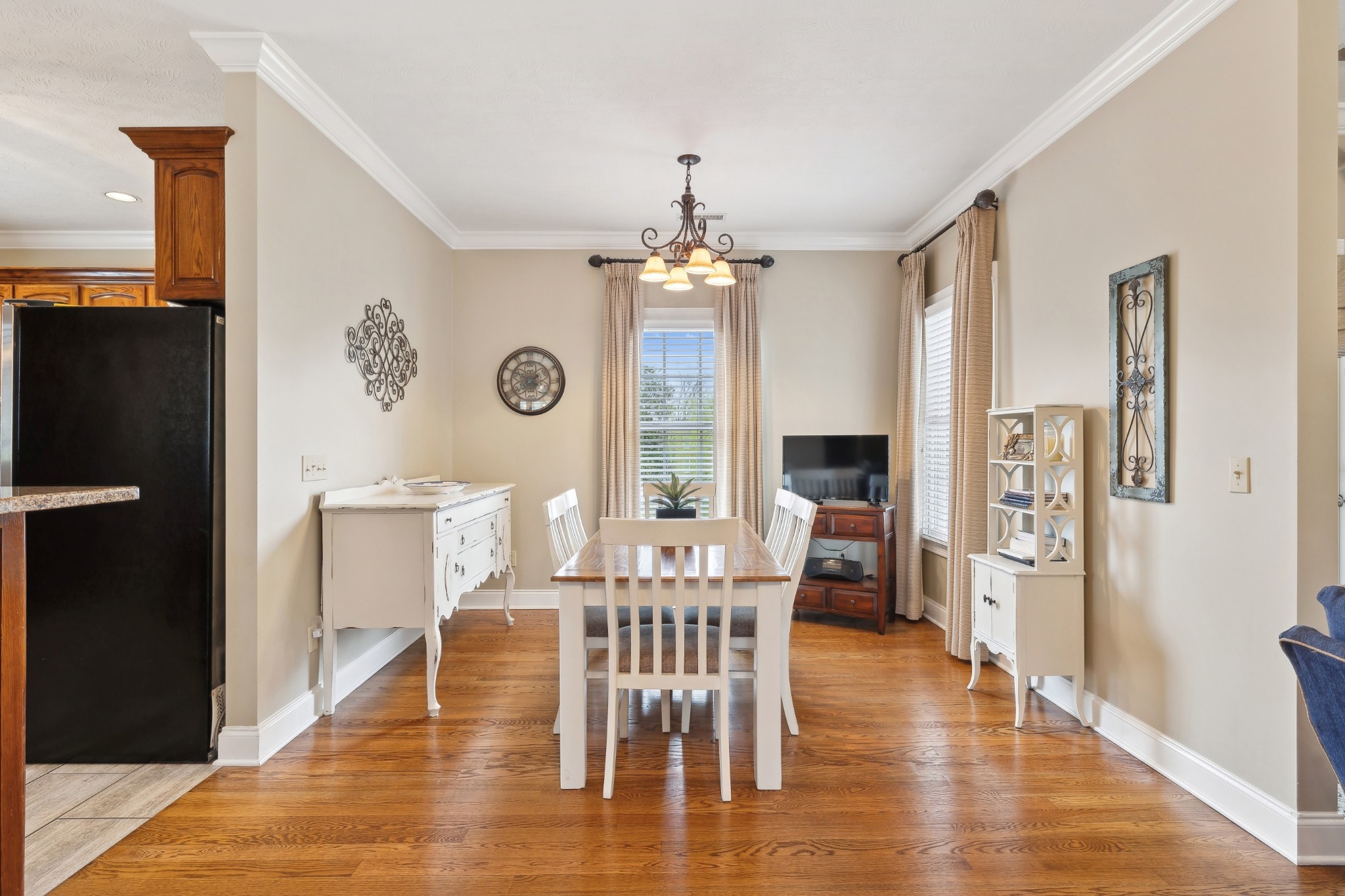 2108 Rodman Boulevard Gallatin, TN 37066 - Photo 10 of 45 a dining room with wooden floor a chandelier a glass table and chairs