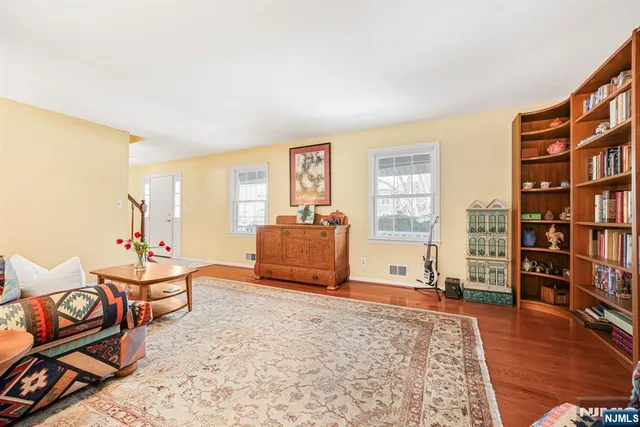 a living room with furniture and a book shelf