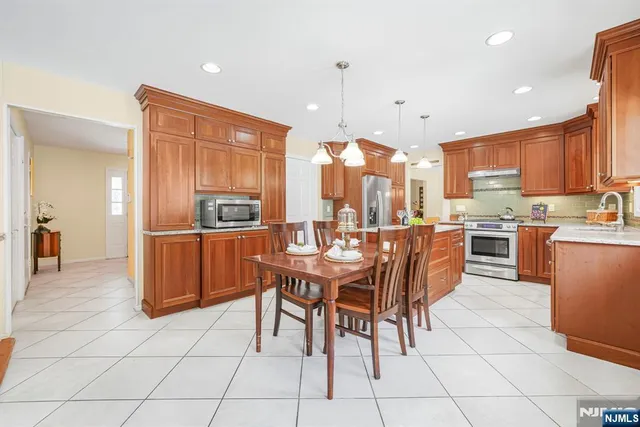 a large kitchen with a table and chairs