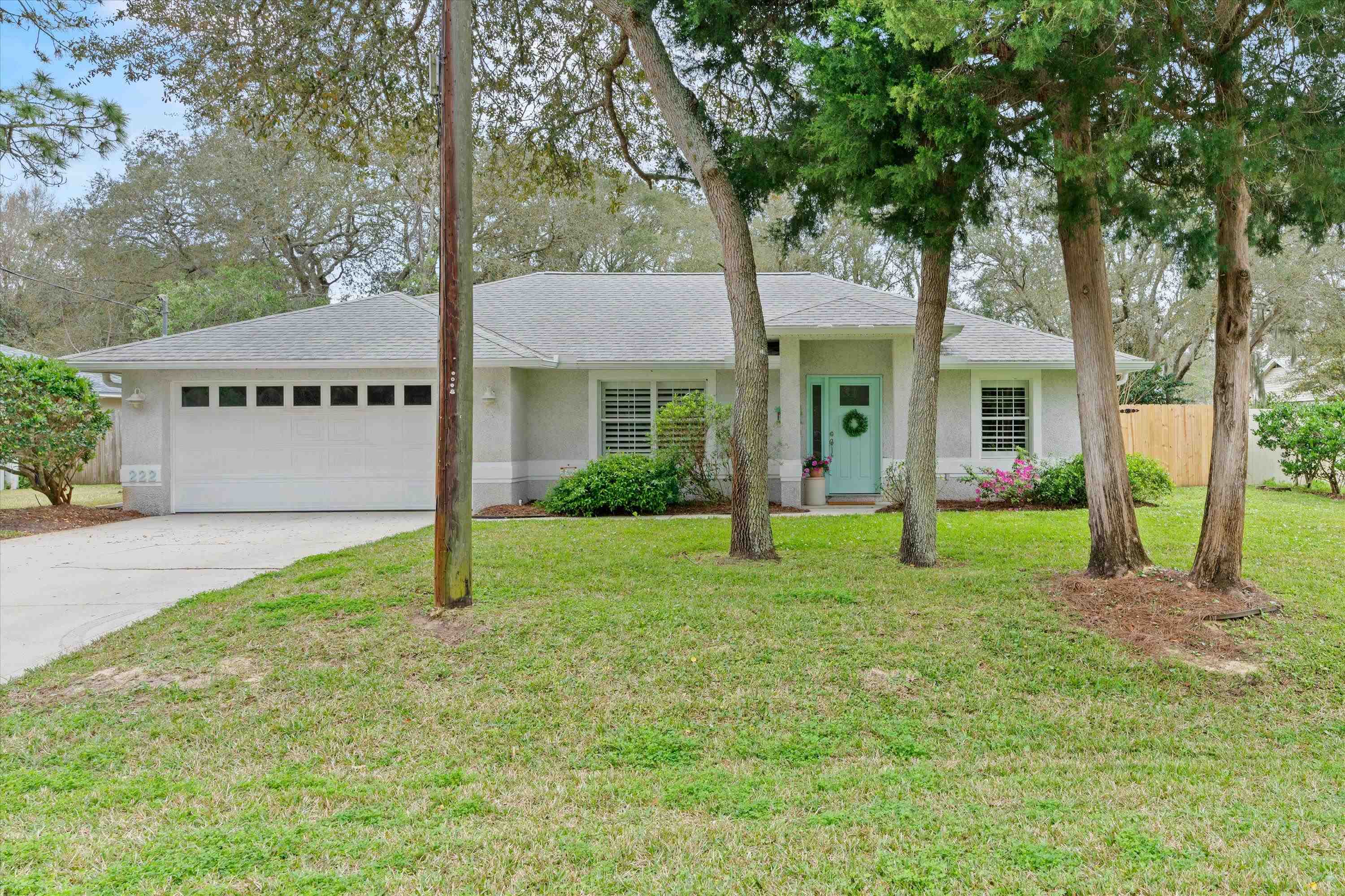 a view of an house with backyard and tree