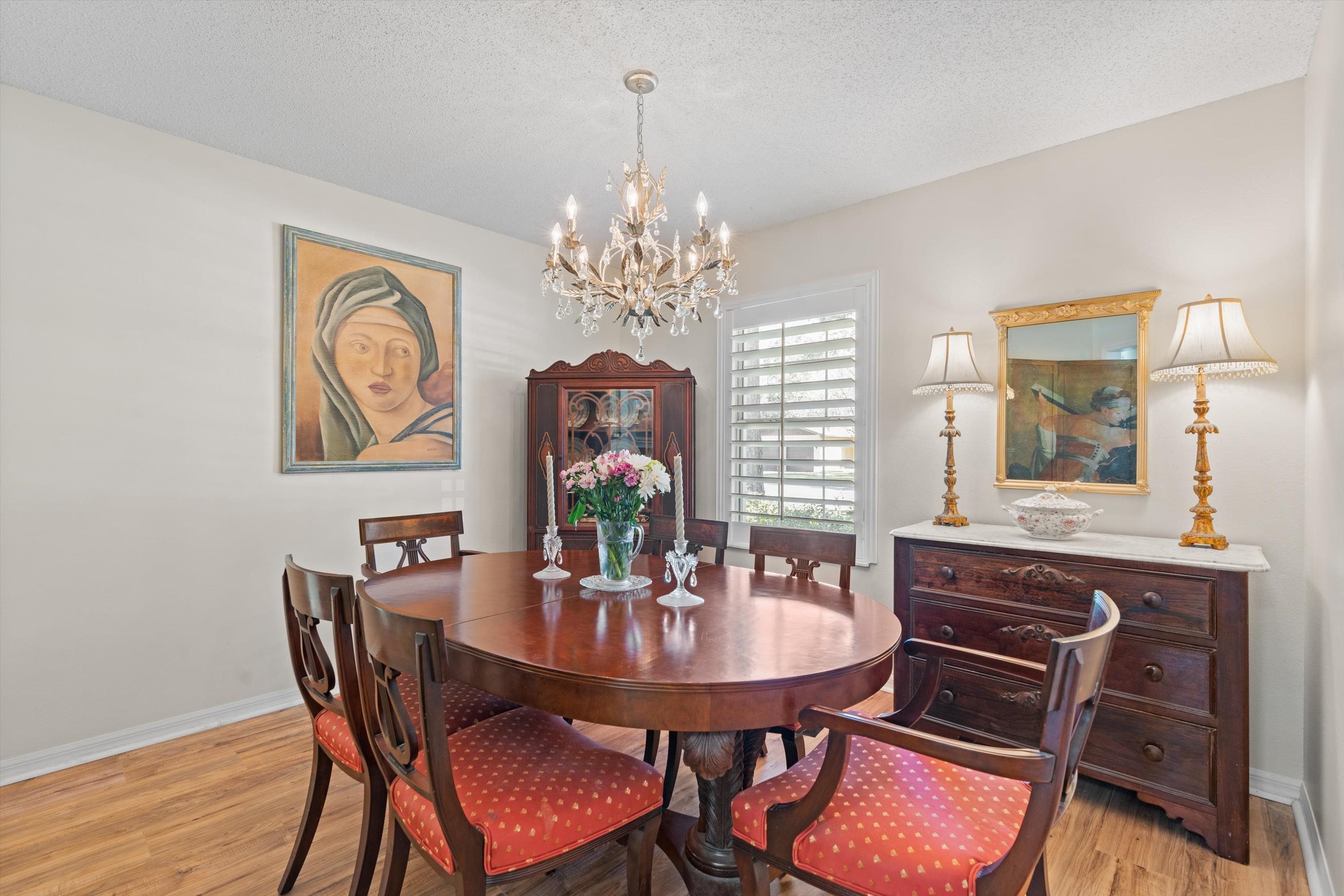 222 Bonita Road St. Augustine, FL 32086 - Photo 18 of 46 a dining room with furniture a chandelier and wooden floor