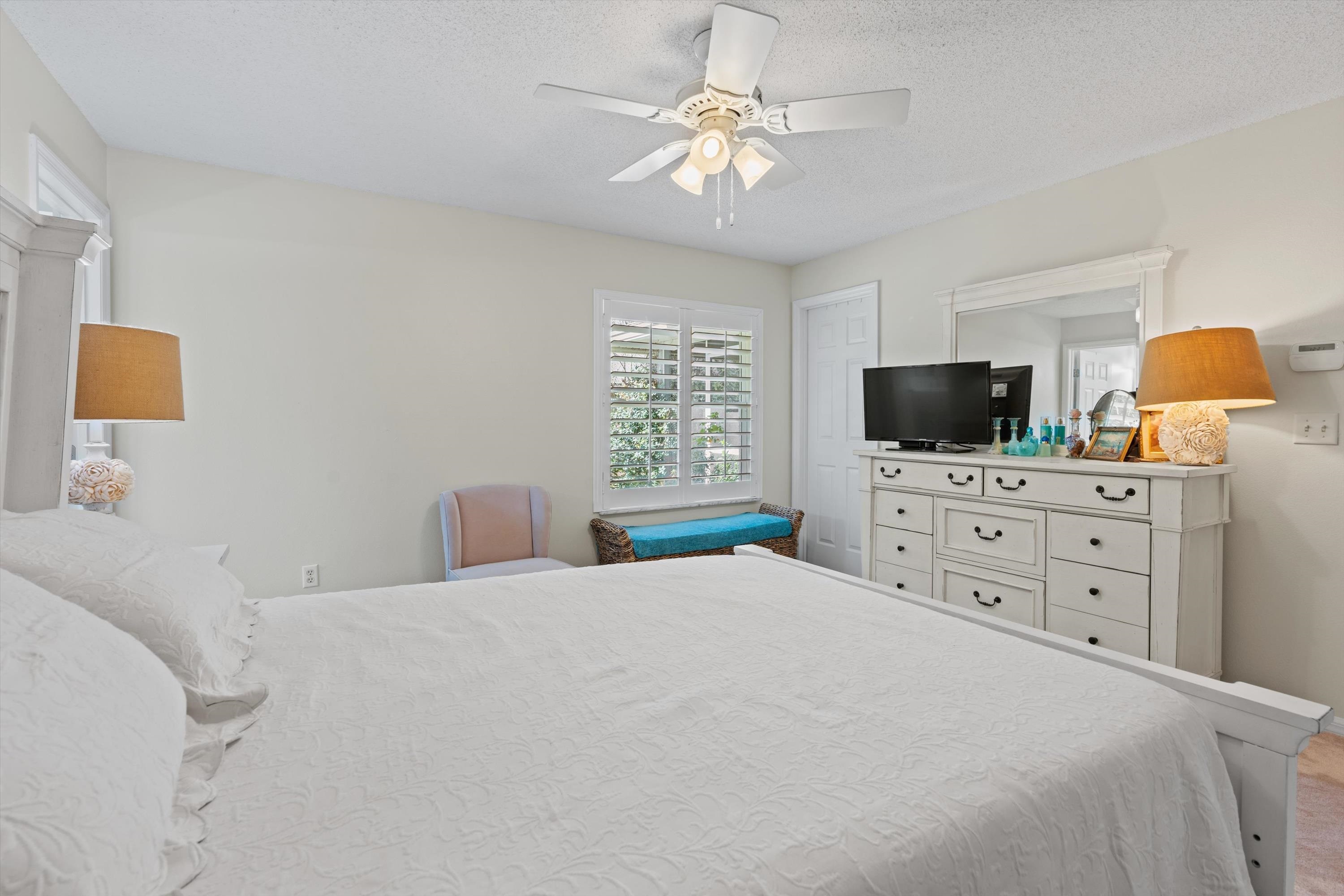 222 Bonita Road St. Augustine, FL 32086 - Photo 22 of 46 a bedroom with a large bed and a flat tv screen on dresser