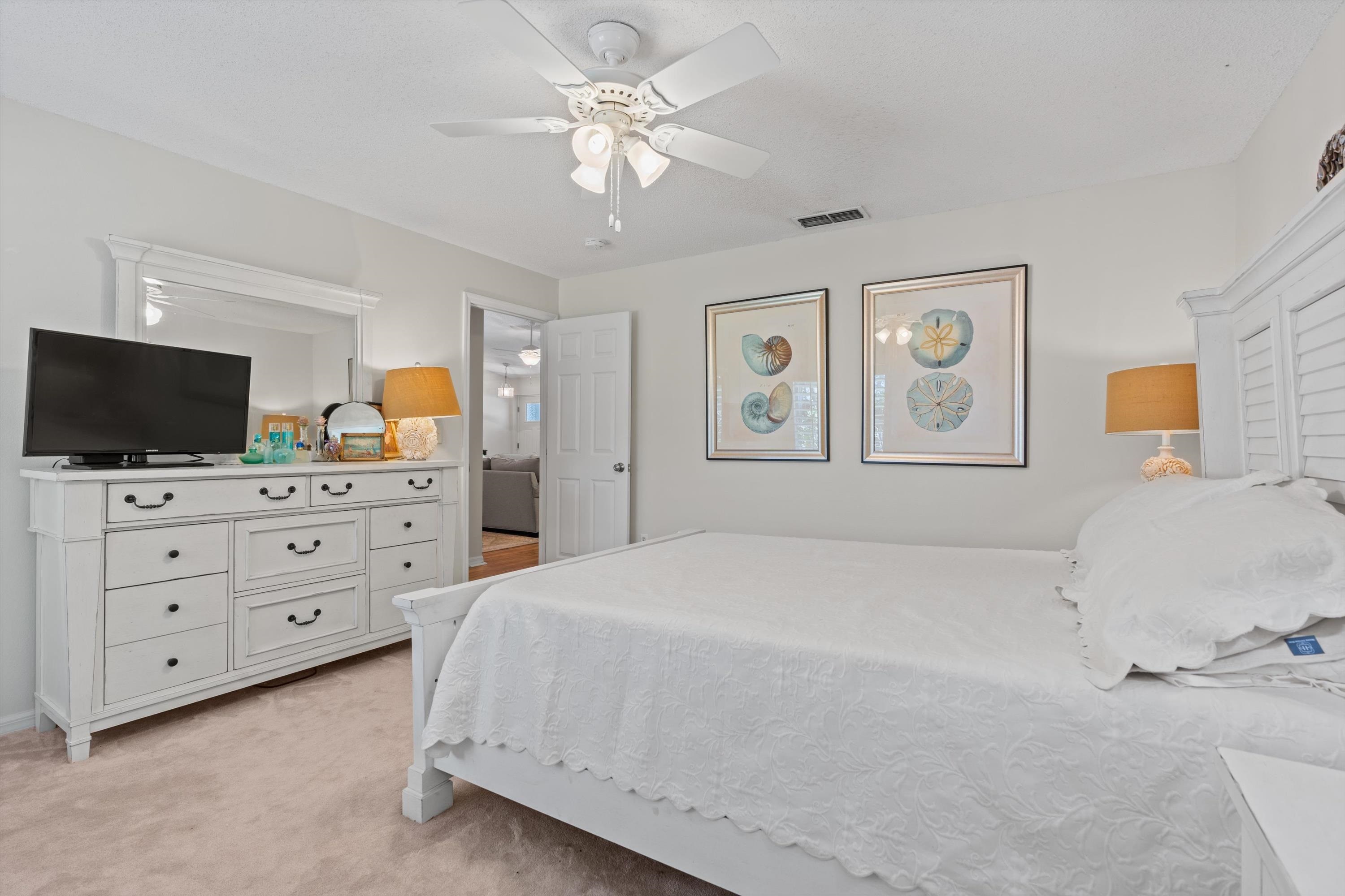 222 Bonita Road St. Augustine, FL 32086 - Photo 23 of 46 a bedroom with a large bed and a flat screen tv