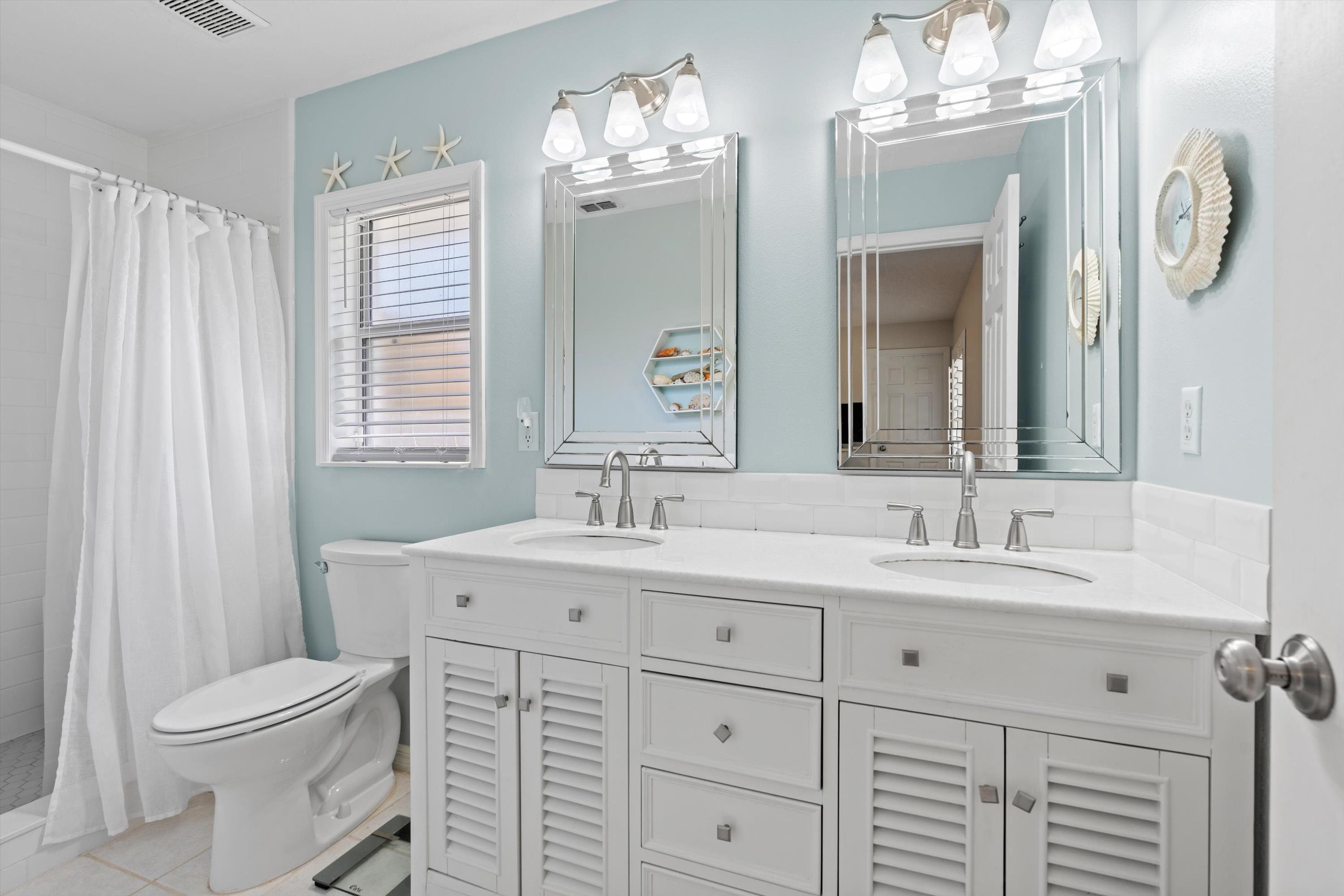 222 Bonita Road St. Augustine, FL 32086 - Photo 24 of 46 a bathroom with a toilet a sink a mirror a and a window
