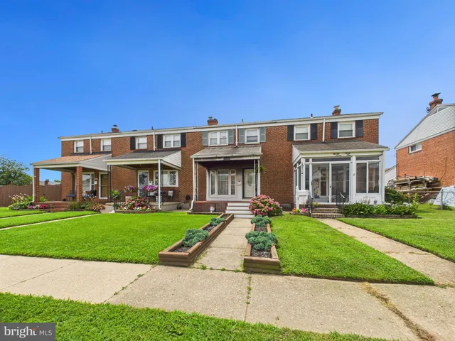 a front view of a house with a yard table and chairs