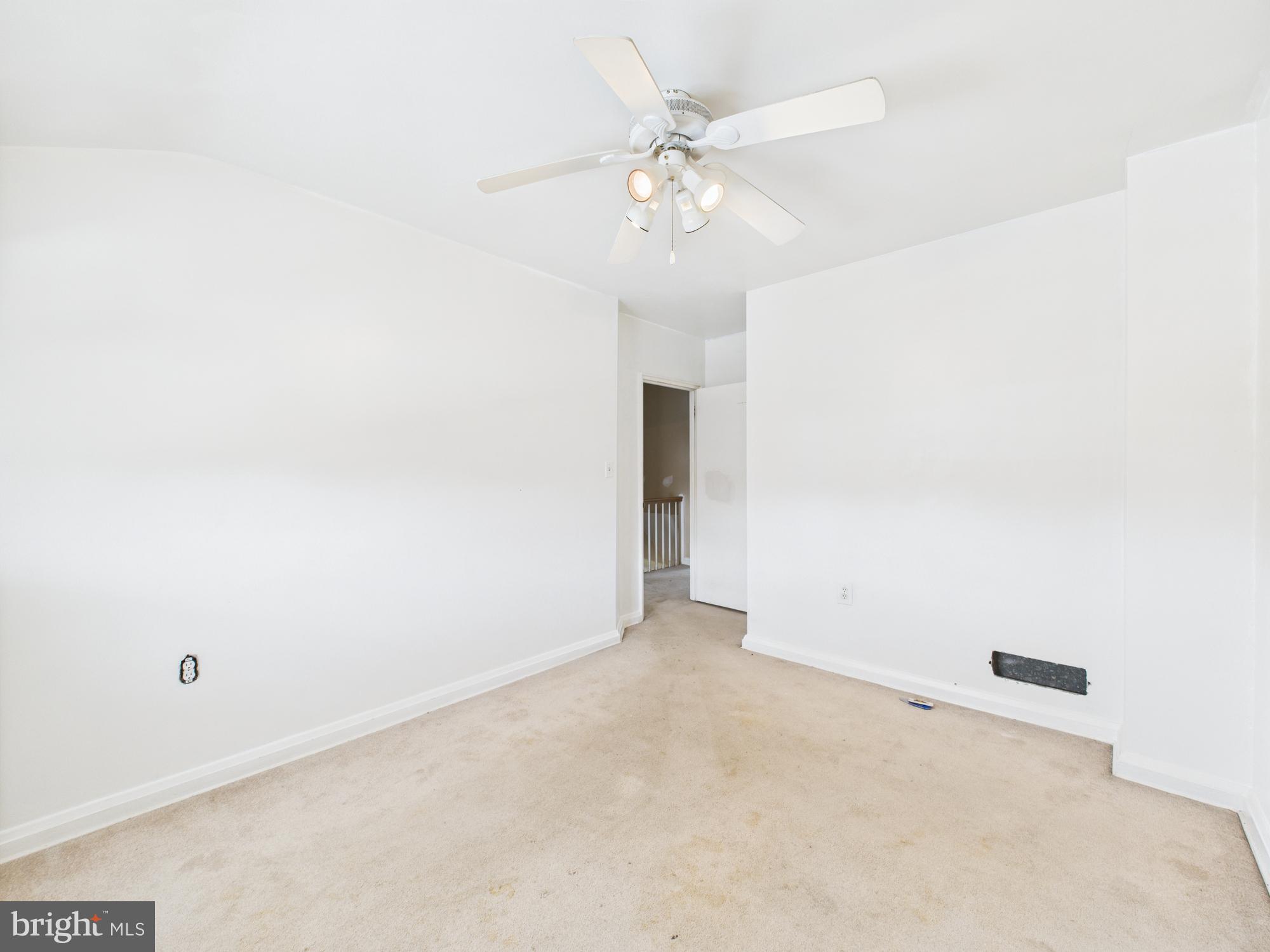 2743 Kirkleigh Road Dundalk, MD 21222 - Photo 12 of 31 an empty room with a chandelier fan and closet