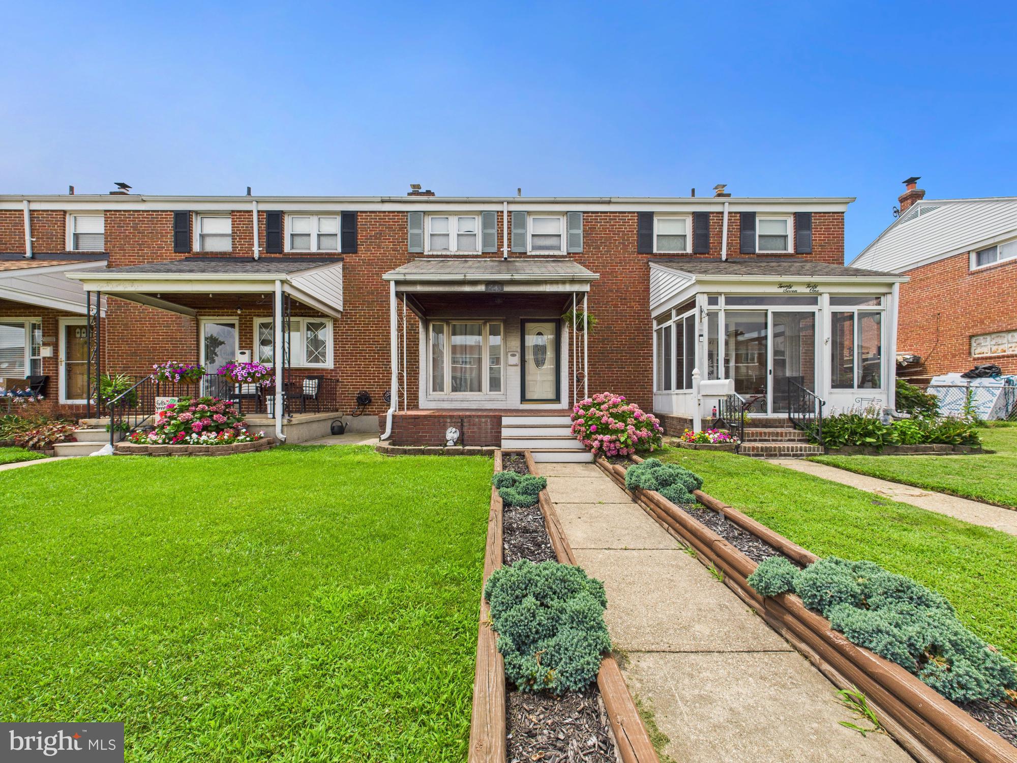 2743 Kirkleigh Road Dundalk, MD 21222 - Photo 16 of 31 a front view of a house with a yard table and chairs