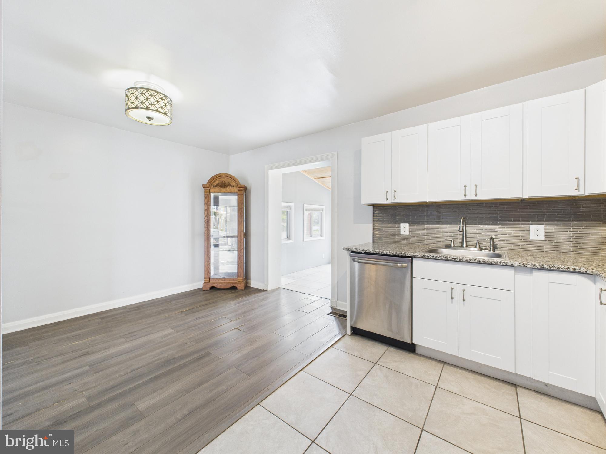 2743 Kirkleigh Road Dundalk, MD 21222 - Photo 18 of 31 a view of a kitchen with granite countertop cabinets and wooden floor
