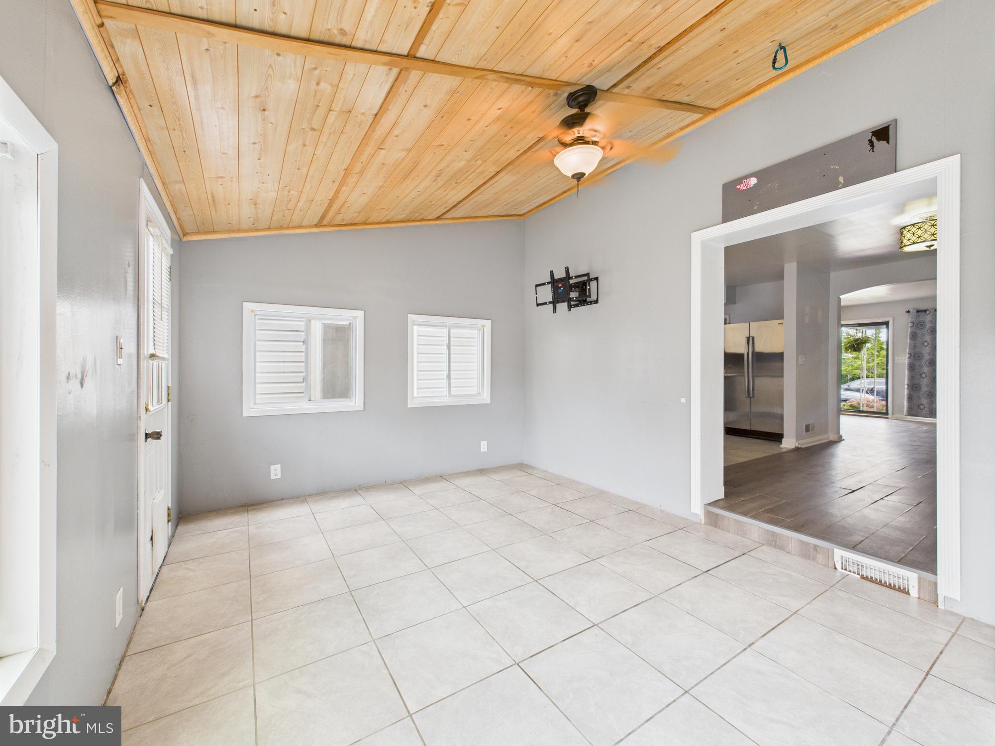 2743 Kirkleigh Road Dundalk, MD 21222 - Photo 23 of 31 a view of a hallway with wooden floor and a chandelier