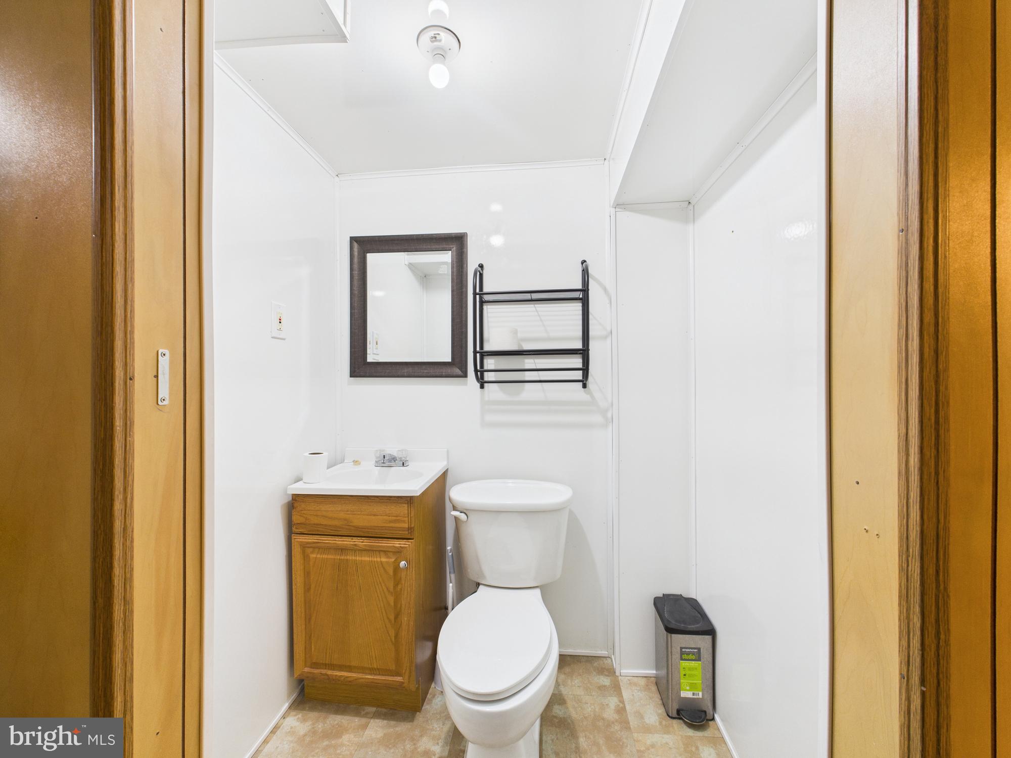 2743 Kirkleigh Road Dundalk, MD 21222 - Photo 29 of 31 a white toilet sitting next to a bathroom sink