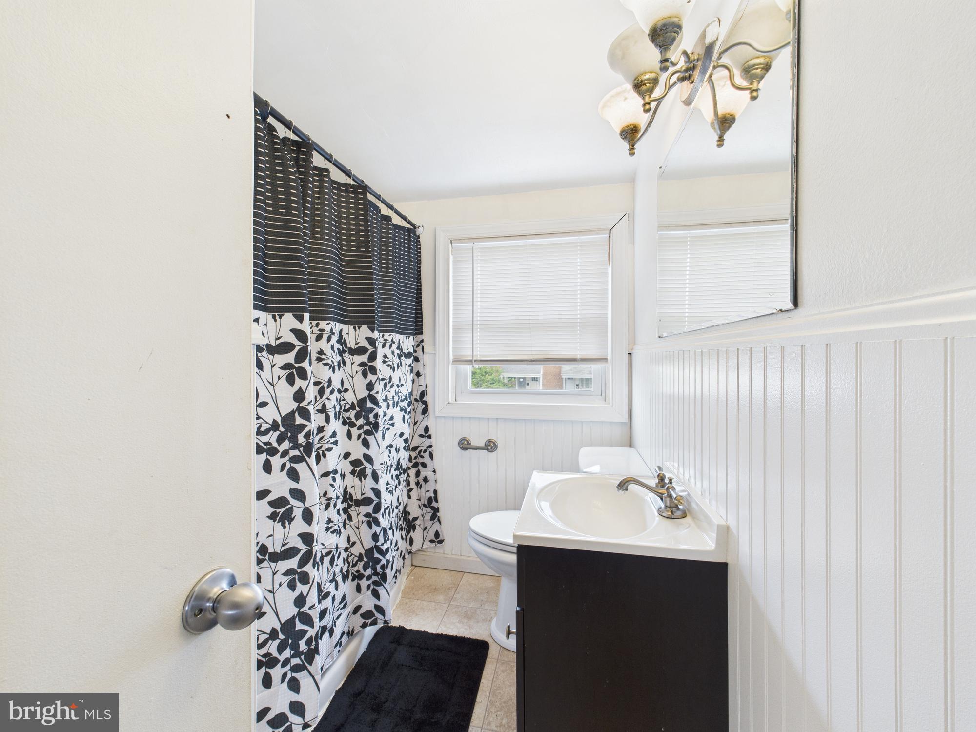 2743 Kirkleigh Road Dundalk, MD 21222 - Photo 30 of 31 a bathroom with a sink toilet and shower