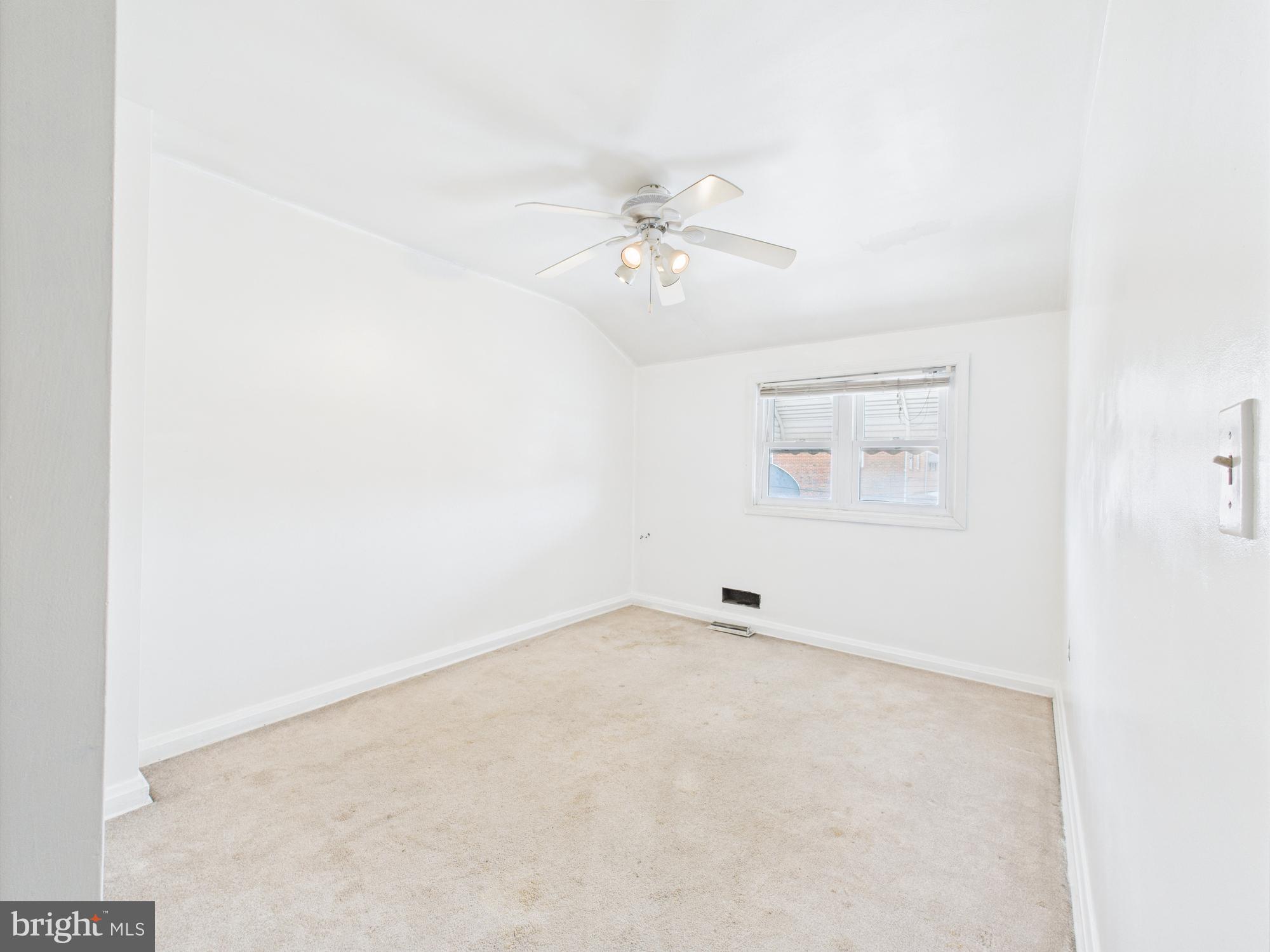 2743 Kirkleigh Road Dundalk, MD 21222 - Photo 6 of 31 an empty room with a window and ceiling fan