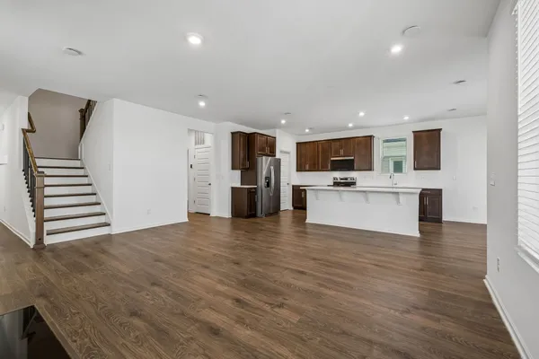 a view of kitchen with wooden floor and electronic appliances