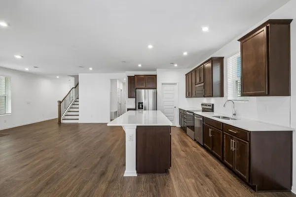 a large kitchen with stainless steel appliances lots of counter top space