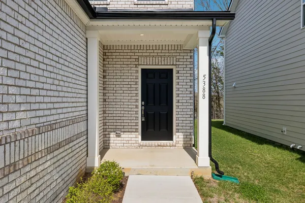 a front view of a house with a garden