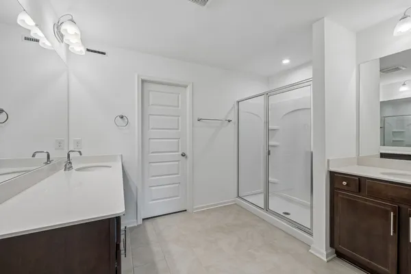 a spacious bathroom with a granite countertop sink mirror and double