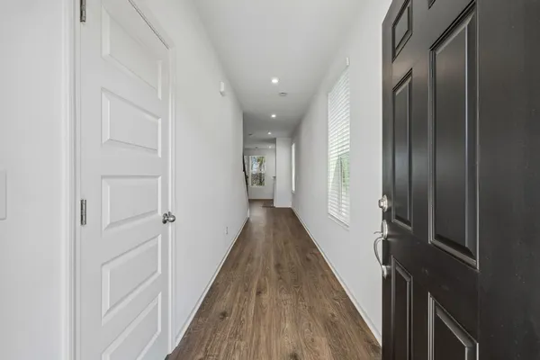 a view of hallway with wooden floor