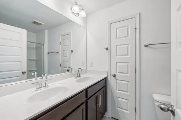 a bathroom with a sink double vanity and a mirror