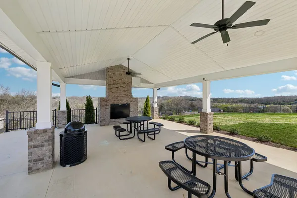 a living room with patio furniture and a floor to ceiling window