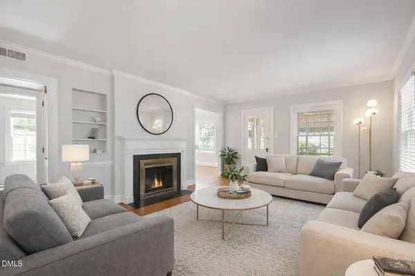 a living room with furniture and a fireplace