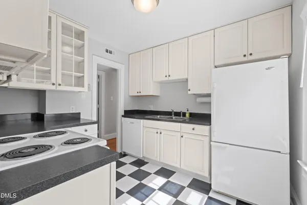 a kitchen with cabinets and white appliances