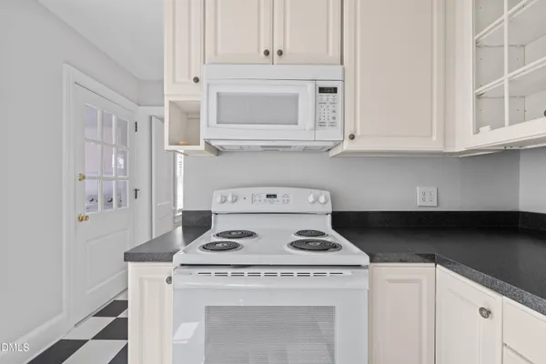a stove top oven sitting inside of a kitchen