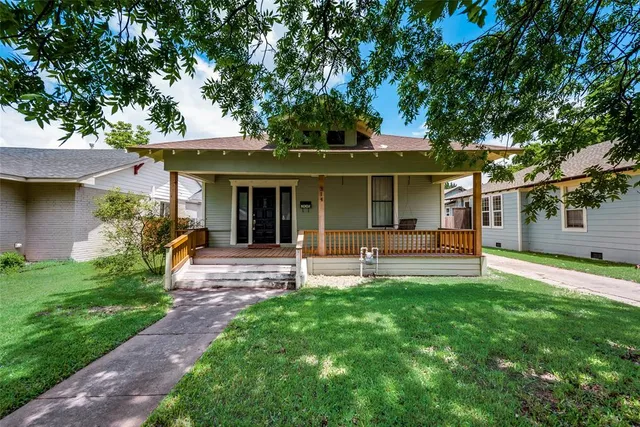 a view of a house with a yard and sitting area